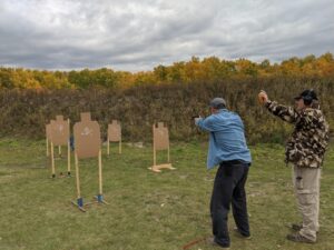 A competitor in a pistol match shoots targets.